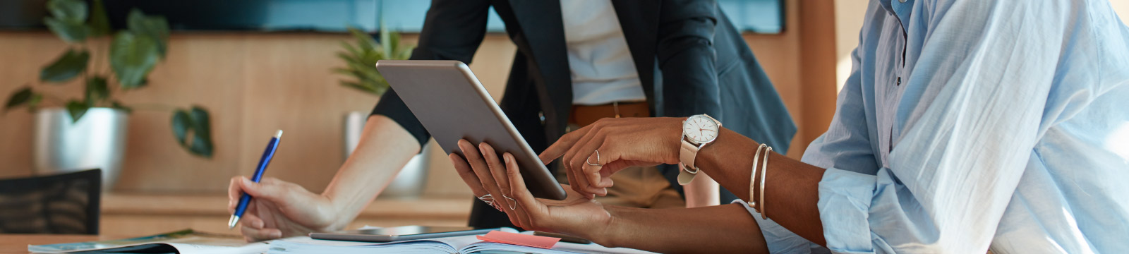 Business meeting between two people looking at a tablet.