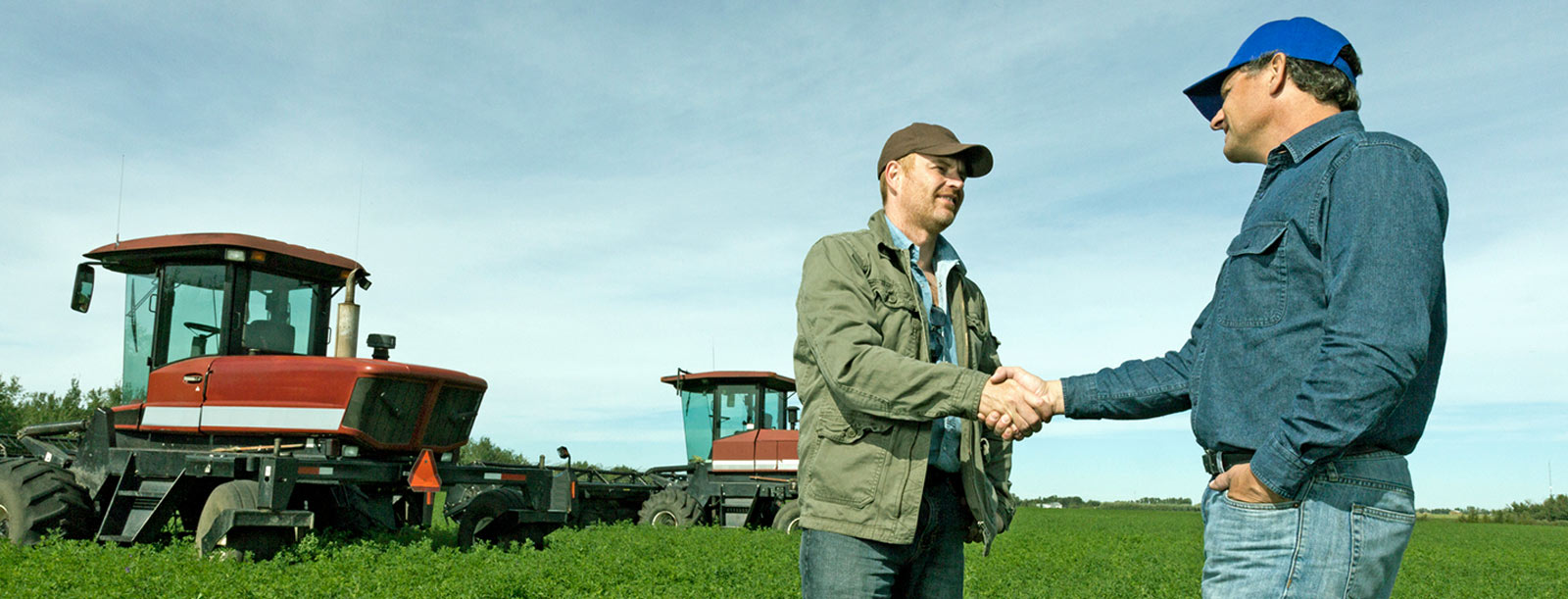 Farmer and their bank lender shaking hands.